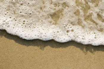 Close-up of sand and wave.
