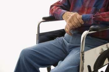 Torso shot of Caucasion elderly man sitting in wheelchair.