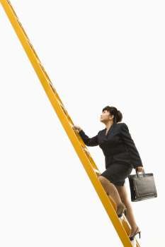 Filipino middle-aged businesswoman climbing ladder carrying briefcase.