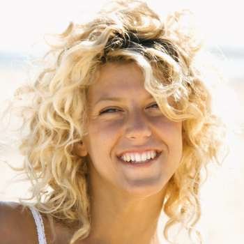 Close up portrait of pretty young blond woman smiling.