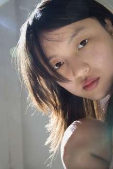 Portrait of pretty young Asian woman making eye contact.