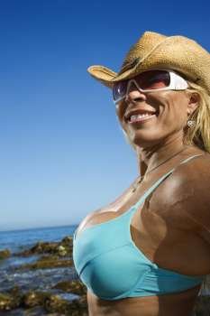 Close up of pretty Caucasian mid adult woman bodybuilder in bikini on Maui beach.