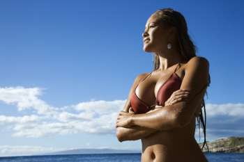 Young adult Asian Filipino in bikini on beach in Maui Hawaii.