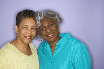 Mature adult African American females looking at viewer smiling.