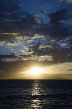Sunset and clouds over the Pacific Ocean off the coast of Kihei, Maui, Hawaii, USA.