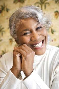 Portrait of mature African American woman smiling at the viewer.
