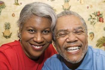 Close up portrait of mature African American couple smiling at viewer.