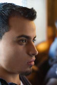 Close-up portrait of serious young hispanic man.