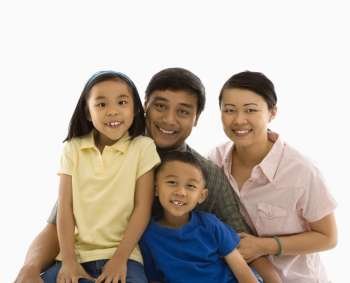 Asian family portrait against white background.