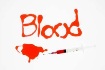Hypodermic needle with red liquid and blood spelt out on white background.