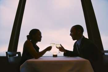 African-American couple toasting wine glasses.