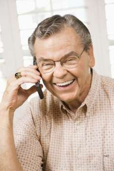 Mature Caucasian man talking on cellphone.