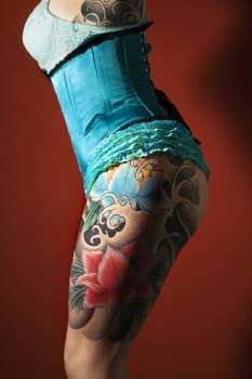 Side of womans tattooed leg