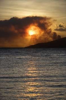 Dark clouds at sunset over water on Maui, Hawaii.