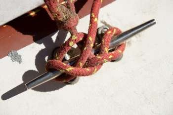 Red rope tied around handle on side of boat.