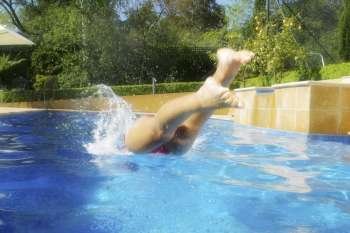 A stock photo of a woman diving into the water