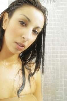 Beauty shot of a youg Australian woman using soap in the shower.