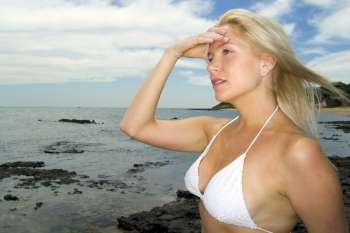 A stock photograph of a beautiful blonde model by the beach.