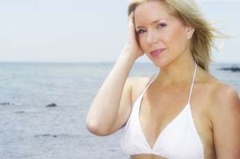 A stock photograph of a beautiful blonde model by the beach.