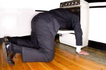 A stock photograph of a man committingasuicide by sticking his head in an oven.