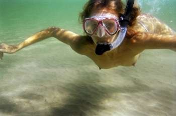 A stock photograph of a beautiful young woman going snorkeling.