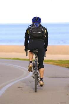A person riding a bicycle on a seashore recreation trail
