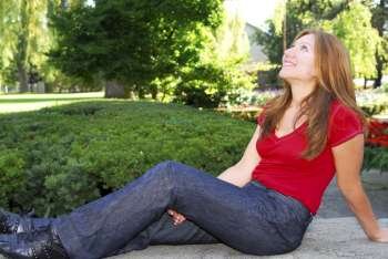 Mature woman relaxing outside in summer park