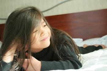 Young girl lying on the bed
