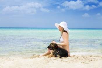 Woman at the beach with a dog