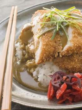 Plated Tonkatsu with Vinegar RiceCurry Sauce and Pickled red Radish