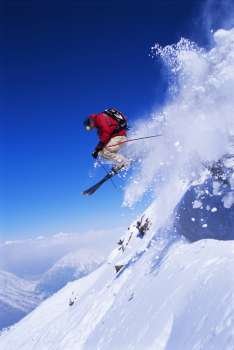 Skier jumping on snowy hill