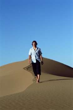 Man outdoors walking in the desert