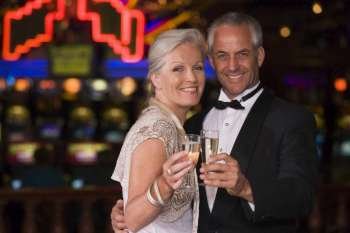 Couple in casino with champagne smiling (selective focus)