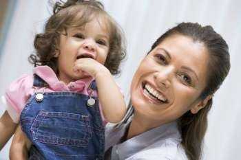 Mother holding IVF child smiling