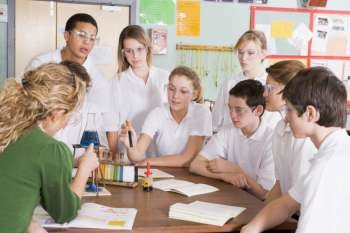 Students receiving chemistry lesson in classroom