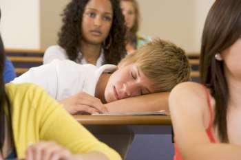 Student in class sleeping (selective focus)
