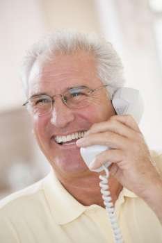 Man using telephone and smiling