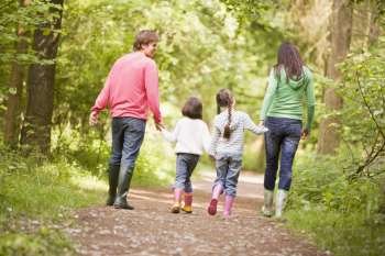 Family walking on path holding hands