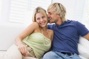 Couple in living room kissing and smiling