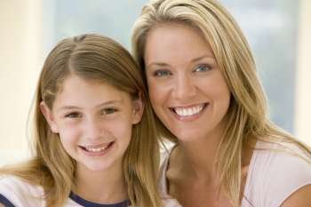 Woman and young girl in living room smiling