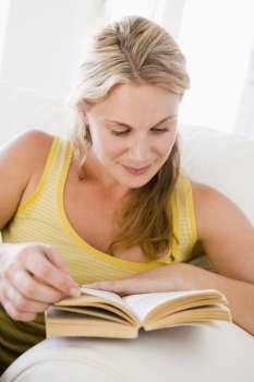 Woman in living room reading book