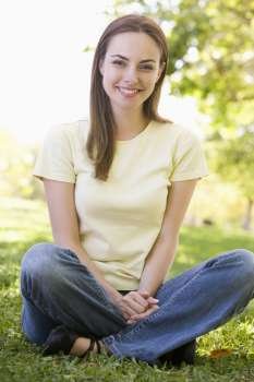 Woman sitting outdoors smiling