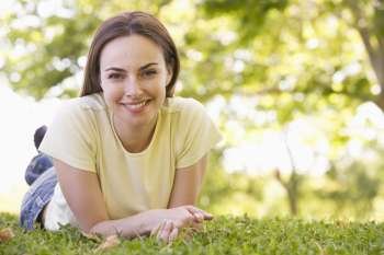 Woman lying outdoors smiling