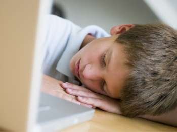 Young Boy Asleep By His Laptop