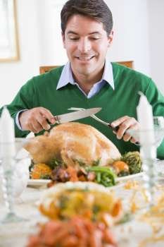 Man Excitedly Carving A Turkey