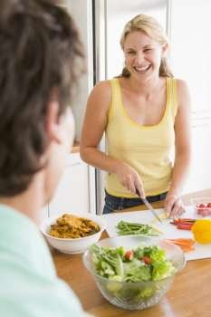 Woman Talking To Husband While Preparing meal,mealtime
