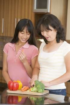 Mother And Daughter Preparing meal,mealtime Together