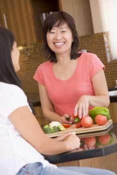 Woman Chatting To Friend While Preparing meal,mealtime
