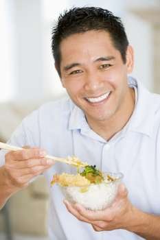 Man Enjoying Chinese Food With Chopsticks