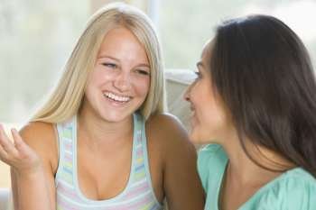 Two Teenage Girls Smiling To Each Other 
